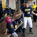 Natalie Harper dances and sings with Katie Luetkens in the Michigan dugout on Saturday, May 4. Daniel Brenner I AnnArbor.com